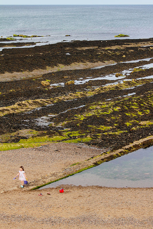 A sample of Rae's photography - a child walking on a beach
